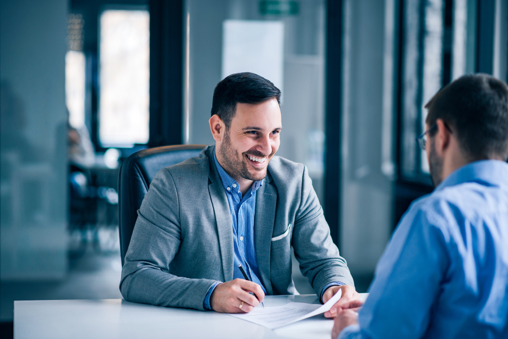 A businessman smiling while interviewing