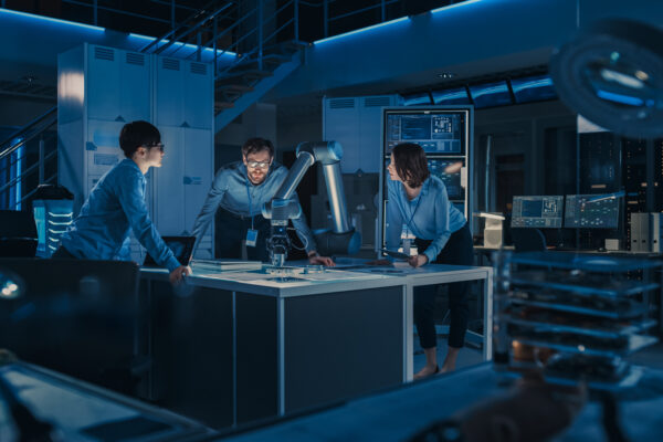 Engineers fabricating metal components in a laboratory